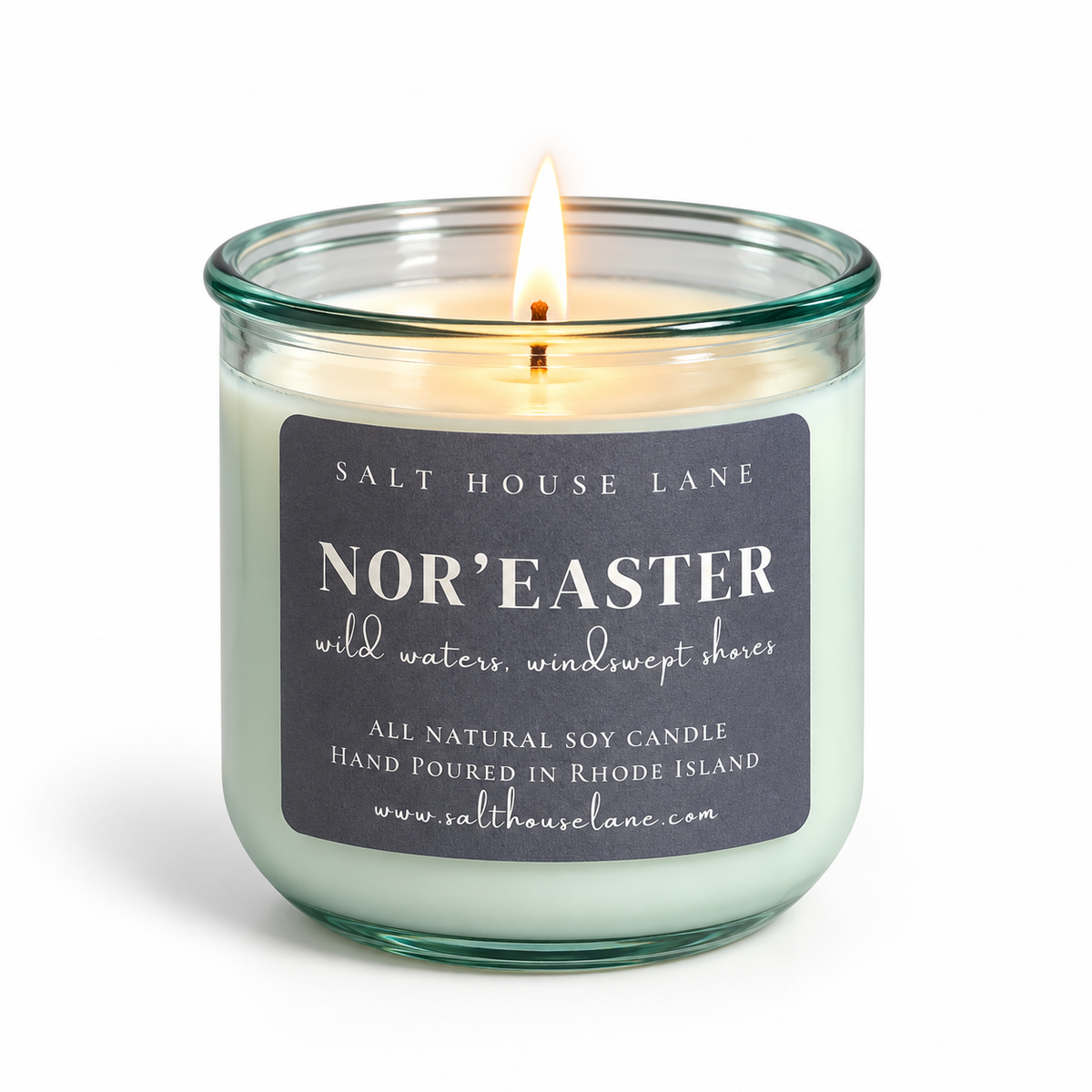 A lit soy candle in a clear glass jar with a dark charcoal label reading 'SALT HOUSE LANE NOR'EASTER' on a white background.